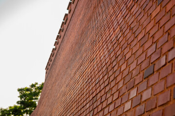 Big brick wall made of orange and red bricks as part of outer wall of Wawel castle in Krakow, poland.