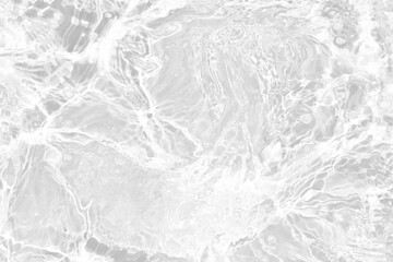 White water with ripples on the surface. Defocus blurred transparent white colored clear calm water surface texture with splashes and bubbles. Water waves with shining pattern texture background.