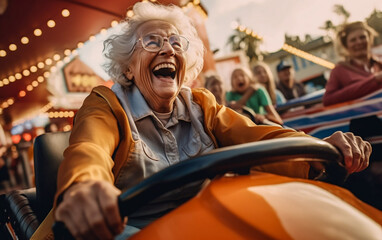 Fototapeta na wymiar A happy elderly woman laughs and has fun on a bumper car