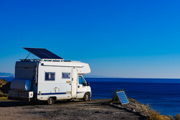 Obraz na płótnie Canvas Caravan with tilt solar panels on roof.