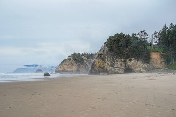 Oregon beach with cliff and cave.