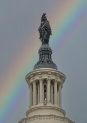 Statue of Freedom on top of US Capital with rainbow