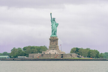 The Statue of Liberty on a Partly Sunny Day at Sunrise © Alex