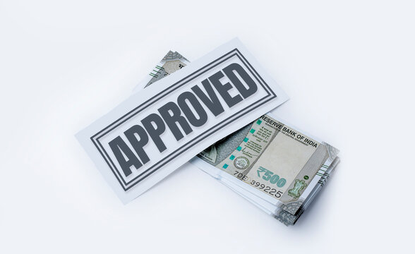 Business Loan Approved Concept: Money Isolated on White Background with Approval Stamp in the Middle. Indian currency, 500 hundred rupee notes