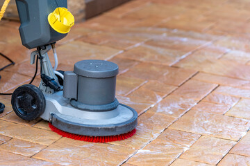 manual cleaning of concrete and stone pavements with a mechanical brush water and detergent