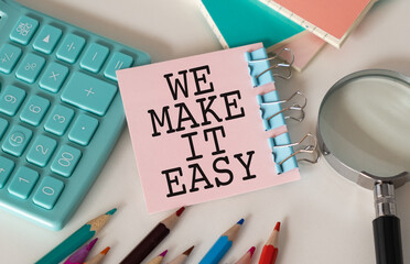 We Make it Easy, text on notepad on white background near keyboard and glasses