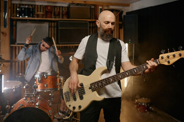 Fototapeta premium Rock rehearsal or live performance with focus on guitarist playing guitar