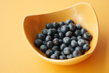 Close up of fresh blue berry in a bowl on table 