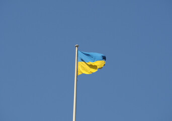 Ukrainian flag of Ukraine over blue sky