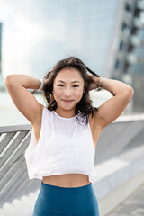 Urban portrait of a beautiful Asian ethnicity young sporty woman