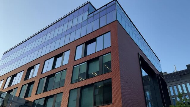 Newly built modern glassed office building exterior. Bottom up view. Wide angle shot