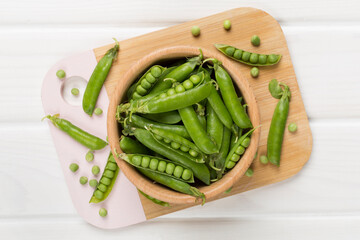 Composition with fresh green peas on wooden background, top view
