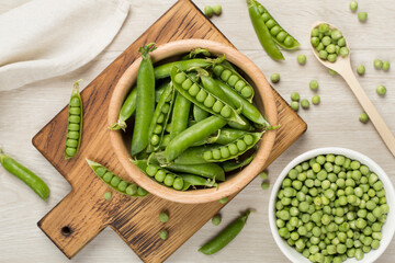 Composition with fresh green peas on wooden background, top view