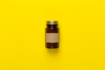 Plastic bottle with vitamins on color background, top view