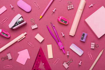 Pink school stationery on color backgroung, top view