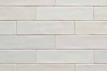 White smooth long thin horizontal tile pattern on a wall, background image. Color swatch design sample.