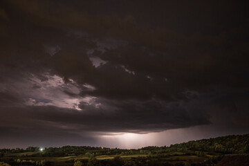 Fototapeta na wymiar Storm clouds and lightning in the night sky