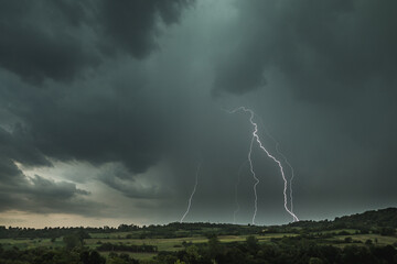 Storm clouds and lightning above the countryside