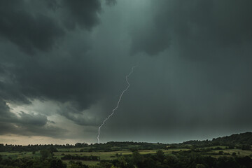 Storm clouds and lightning above the countryside