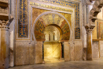 The golden arched mihrab or prayer niche used to identify the wall that faces Mecca inside the great Mezquita mosque cathedral in Cordoba, Spain.