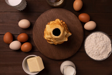 Top view baumkuchen, sakotis ,sekacz ingredients on wooden table, traditional spit cake of lithuanian, polish, german, belarusian cuisine made of butter, eggs, flour, sugar. Horizontal plane