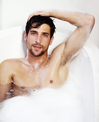 Portrait, hygiene and a sexy man in a bath in his home for soap cleaning, grooming or body care....