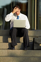Laptop, outdoor and business man stress, worry and sad for job fail, online mistake or news,...