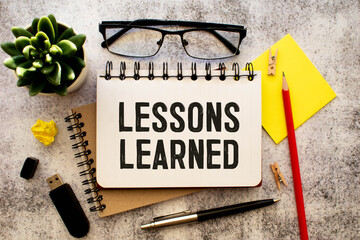 blank card with text Lessons learned on wooden background. Business concept.