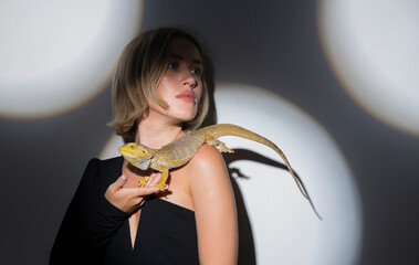 portrait of a woman with a bearded dragon lizard