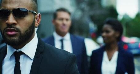 Bodyguard, protect and business people on street as career for safety of executives and boss. Determined, security guard and professional together in city with protection are walking in the outdoor.