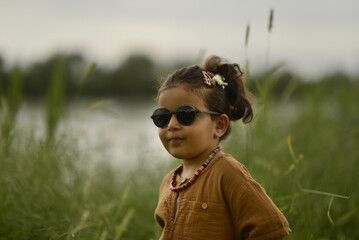 little girl playing by the river in the park
