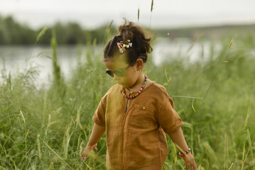 little girl playing by the river in the park