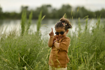 little girl playing by the river in the park