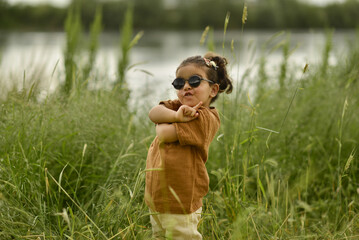 little girl playing by the river in the park