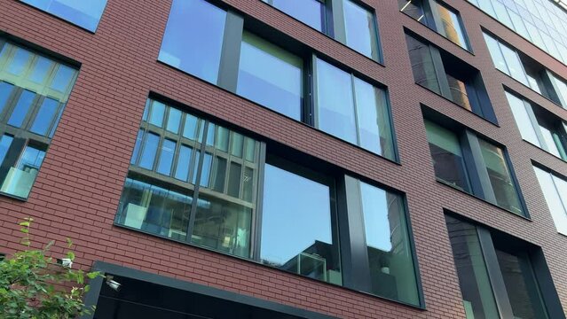 Newly built modern glassed office building exterior. Low wide angle shot
