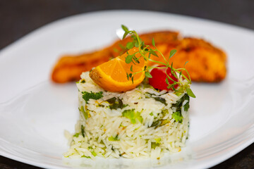 Chic plate of grilled salmon with broccoli rice garnished with fine herbs. real food