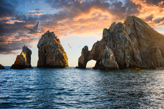 Seagulls soaring above the distinctive arch of Cabo San Lucas, a rock formation close to the peninsula's southernmost tip at Cabo San Lucas, Baja California, Mexico.