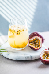 Pure passion, alcoholic cocktail with syrup, lime, orange juice, soda, ice and passion fruit