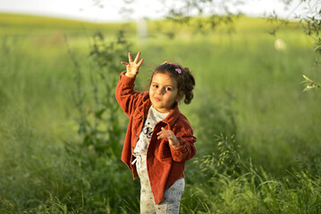 little girl playing and having fun by the river
