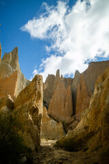 Vertical portrait of a natural rock formations against a blue sky.