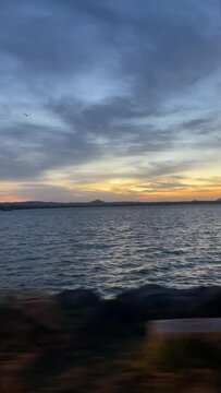  sunset in 'Parakrama Samudraya' Sri Lanka during the windy season. rhythmic water waves. tourist destination. 