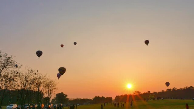 .Chiang Rai,Thailand - February 18,2018:sweet sunrise on the back of .colorful hot air balloons festival at Singha Park in Chiang Rai. .scenery sunrise flying colorful ballon background..