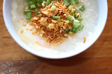 Congee in a bowl with fried garlic and onion