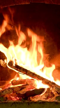 Fire burning in a brick fireplace, flames, flying ash. High quality 4k footage