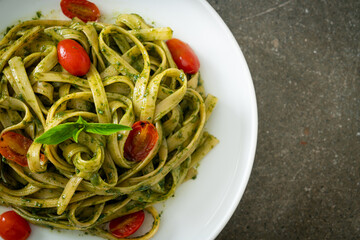 fettuccine spaghetti pasta with pesto sauce and tomatoes