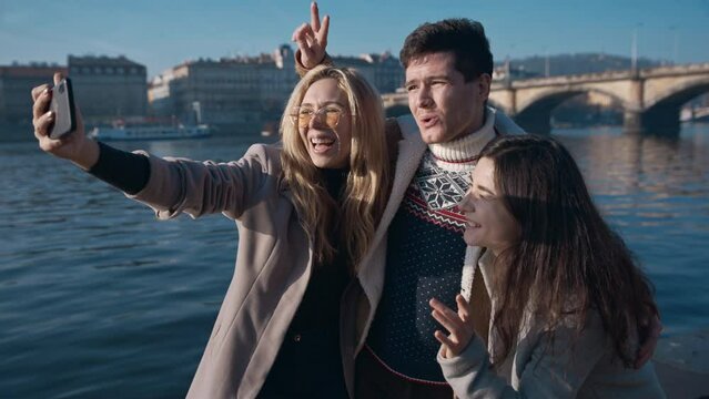 Three friends taking selfe in Prague. Travel, friendship, youth, millenial, blogger, fame social media concept. Filmed on REd 4k, 10 bit color