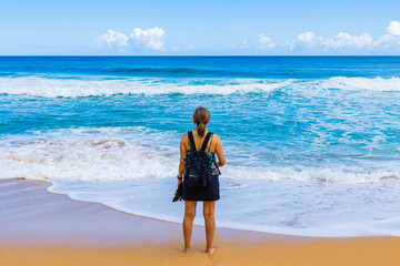 Female Tourist on The Sandy Shore of Kauapea Beach, Kauai, Hawaii, USA