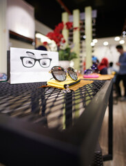 Fashion sunglasses on shelf in store. Selective focus