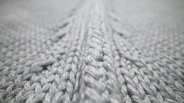 The structure of the fabric. Close-up of knitted cotton fabric. Dolly shot