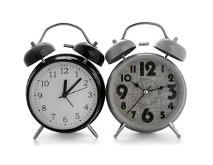 Metal alarm clocks on white background